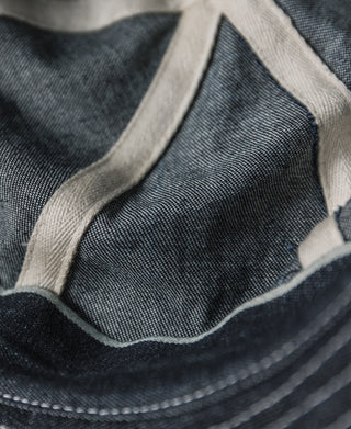 Indigo denim bucket hat interior lining close-up with brim stitching