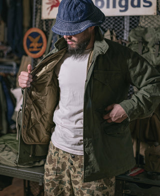 Olive quilted field jacket liner with front pockets and insulation