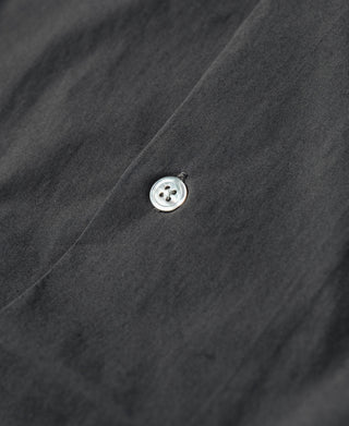 Dark gray shirt placket with round front button