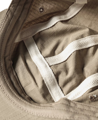 Khaki ripstop cotton cap interior with curved seam and stitched brim edge