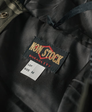 Camo parka interior size M tag on dark fabric near neck