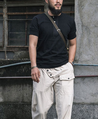 Black henley T-shirt with short sleeves and buttoned neckline placket