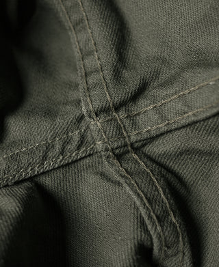 Olive bermuda shorts close-up of cross-stitch at fly seam