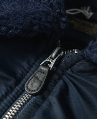 Navy flight jacket with front zipper and leather pull tab detail