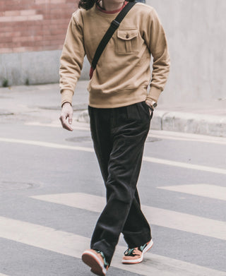 Black corduroy trousers with wide straight fit and side pockets