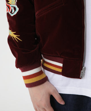 Wine red reversible jacket sleeve cuff with striped ribbing and snap-back pocket
