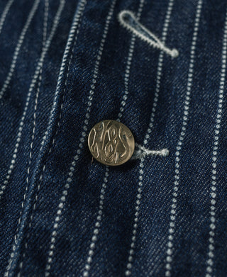 Indigo denim work vest with brass button and white stripe pattern detail