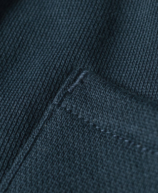 Navy cotton-terry sweatpants, close-up of embroidered stitching detail