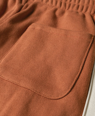 Orange front pocket and smooth side seam on cotton-terry sweatpants