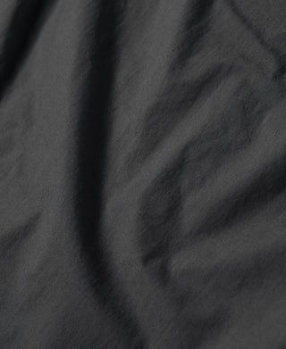 Dark gray shirt chest panel with curved seam