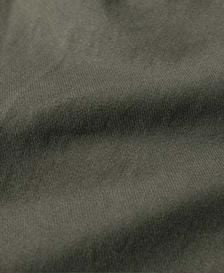 Olive bermuda shorts fabric close-up with fine twill texture