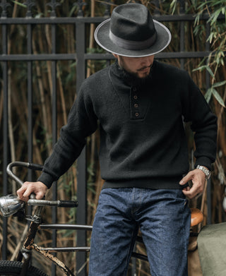 Black wool high-neck sweater with button placket, ribbed cuffs, and ribbed waistband