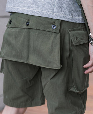 Olive utility shorts with front flap cargo pocket and button front waist