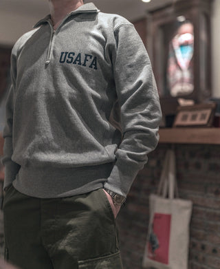 Gray half-zip sweatshirt with USAFA logo at the chest, side angle