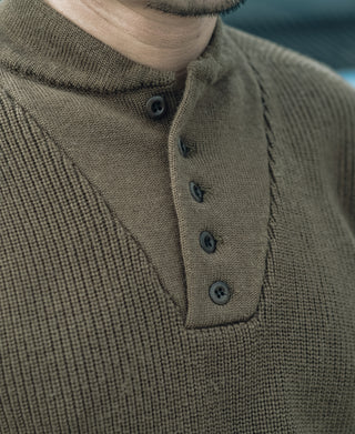 Olive wool high-neck sweater with button placket and four dark buttons