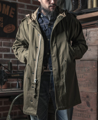 Olive hooded parka with front zipper, buttoned placket, and chest flap pockets