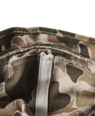 Close-up of camo bucket hat interior seam near brim