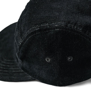 Black corduroy 5-panel cap close-up of crown stitching and eyelets