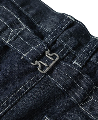 Indigo denim fatigue dungarees, metal suspender-style fasteners at front