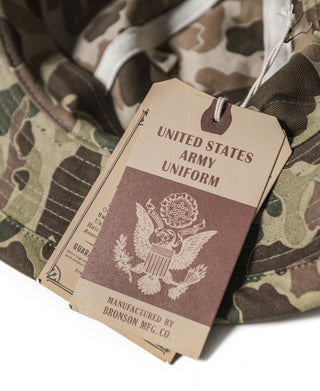 Hang tag on camo bucket hat reading United States Army Uniform