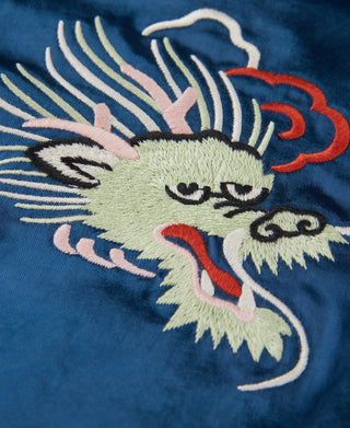 Blue reversible jacket with embroidered lion-dog face and swirling accents
