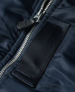 Navy flight jacket zipper with mesh pocket panel near the front