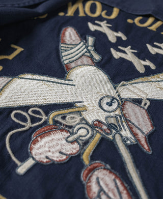 Navy tour jacket embroidery close-up with aircraft and aircraft club-style lettering.