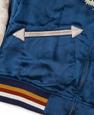 Blue reversible jacket interior side with buttoned snap pockets and striped hem