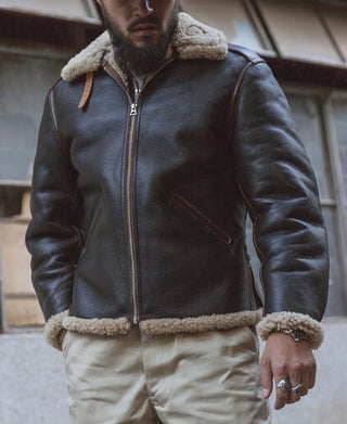 Dark brown flight jacket with tan shearling collar and cuffs, zip front, side pocket