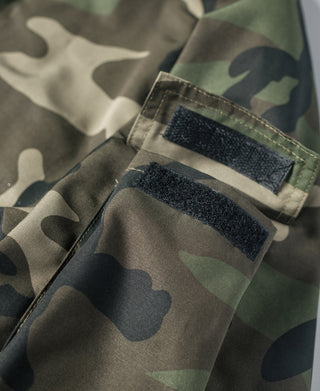Camo parka sleeve pocket with hook-and-loop patch and green camo lining