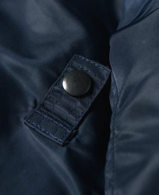 Navy flight jacket sleeve tab with round snap button