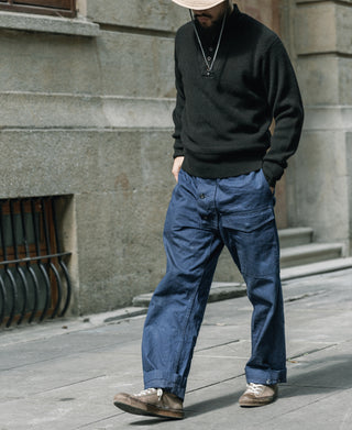 Black wool high-neck sweater, ribbed hem and cuffs, featuring a short button placket