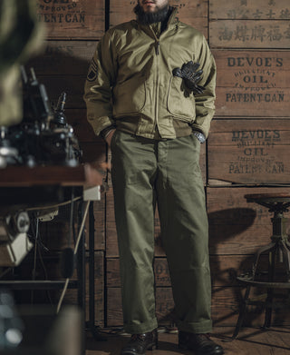 Olive M-43 field trousers on person, full body view with straight legs and cuffed hem