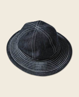 Indigo denim bucket hat with stitched swirl panel on crown and striped brim
