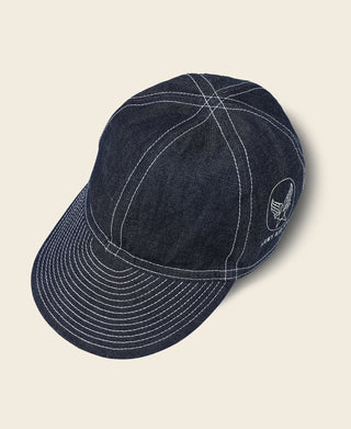 Indigo denim A-3 style cap with circular side patch and curved top stitches