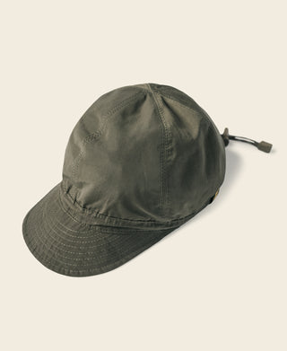 Olive reversible nylon cap with curved brim and side tie strap