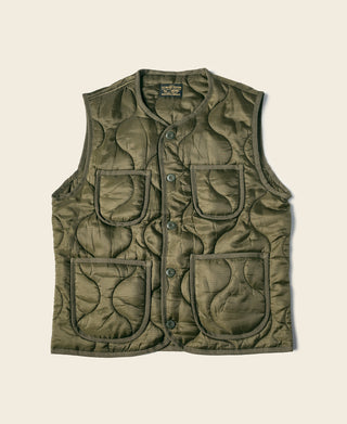 Olive quilted padded nylon vest with snap front and four utility-style pockets