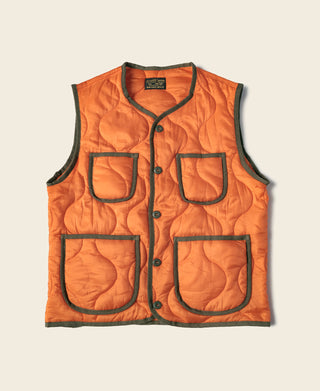 Orange quilted padded ripstop vest with black trim, button front, and four patch pockets