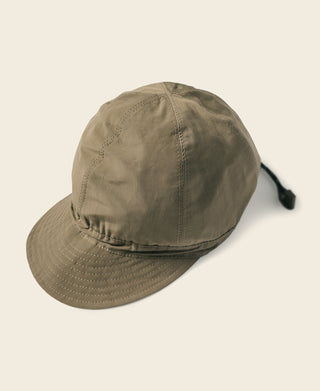 Olive reversible nylon cap with curved brim and side toggle strap