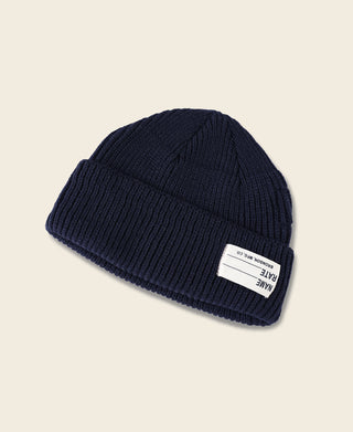 Navy ribbed knit watch cap beanie showing knit texture and folded brim