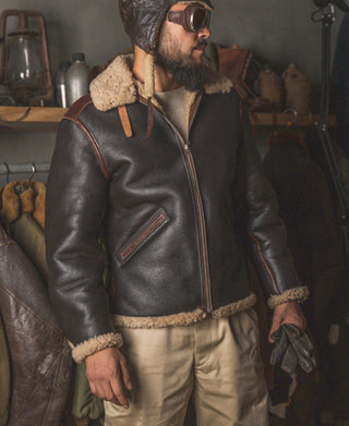 Dark brown leather flight jacket with tan shearling collar, zip front, and chest pocket