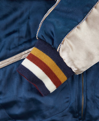 Blue reversible jacket ribbed sleeve cuff with tan, gold, and brown striped band