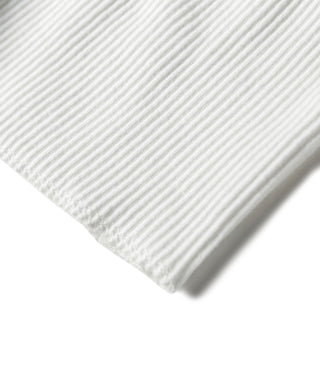 Close-up of white ribbed tank top hem with clean stitched edge