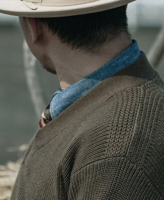 Olive V-neck sweater shoulder with detailed knit texture