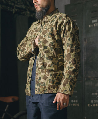 Camouflage button-front jacket with flap pockets and long sleeves, side view