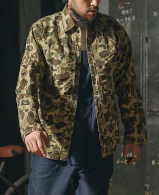 Camouflage button-front jacket with flap chest pockets and dark underlayer