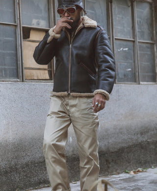Dark brown flight jacket with tan shearling collar and cuffs, front zip and hand-worn styling