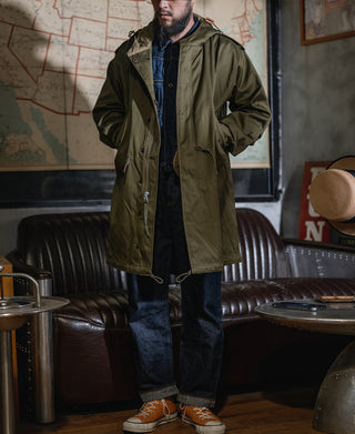 Olive hooded field parka with front zipper, snap placket, and flap pockets