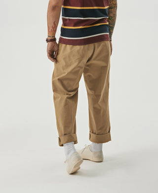Yellow pleated chino trousers with cuffed hems and slanted side pockets