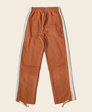 Orange cotton-terry sweatpants with elastic waistband and side pockets, straight-leg fit